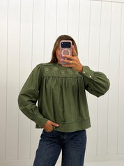 AI-assisted FASHN try-on of Green Puff Sleeve Embroidered Blouse on boutique owner.