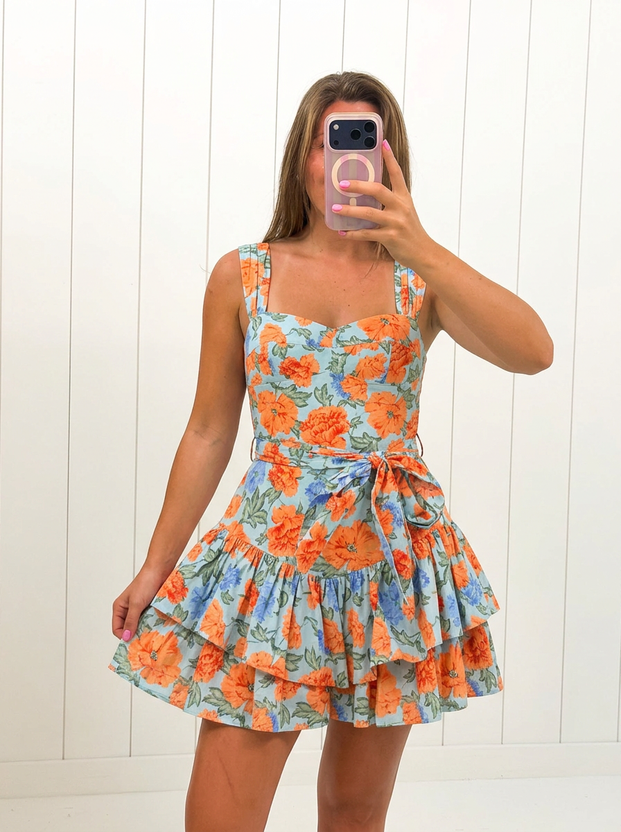AI-assisted FASHN try-on of Orange Ruffle Floral Mini Dress on boutique owner.