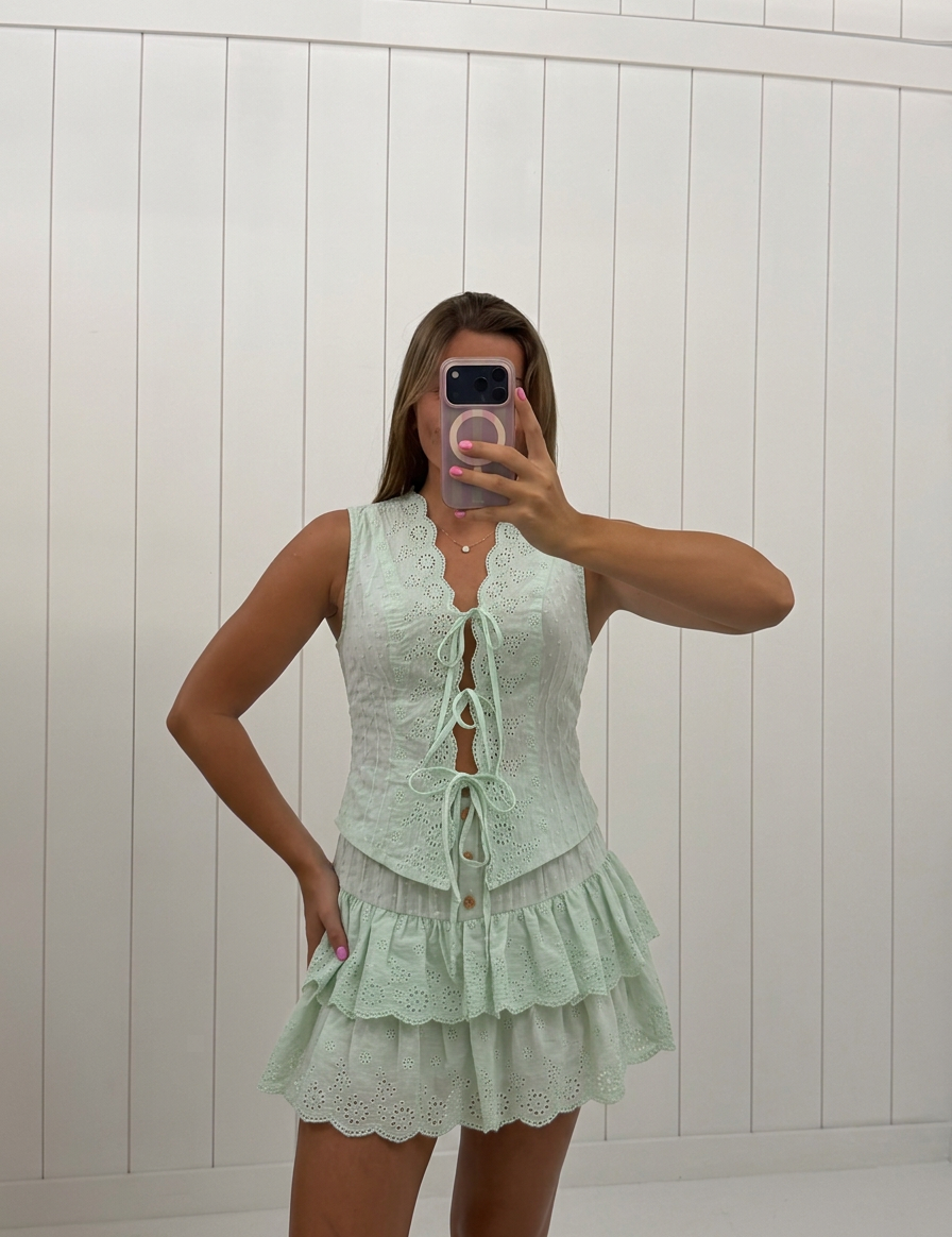 AI-assisted FASHN try-on of Green Eyelet Top and Skirt Set on boutique owner.