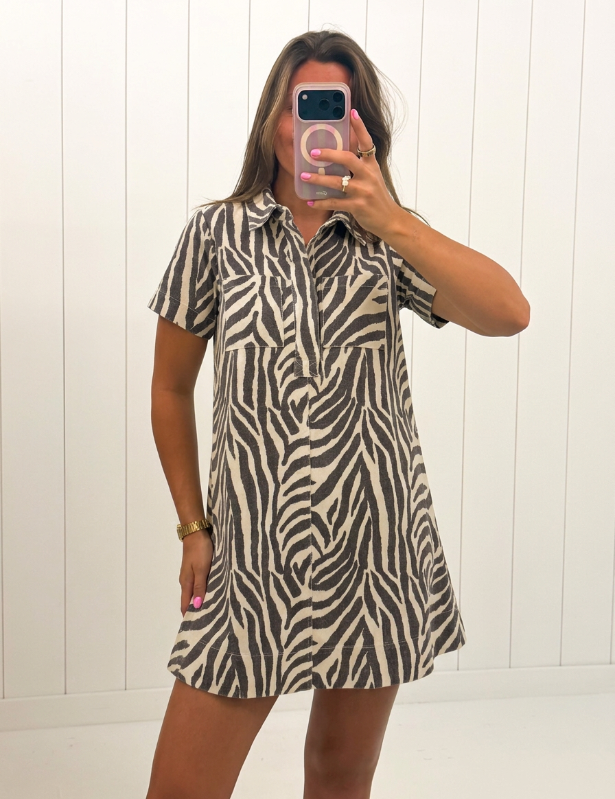 AI-assisted FASHN try-on of Zebra Print Button Collared Mini Dress on boutique owner.