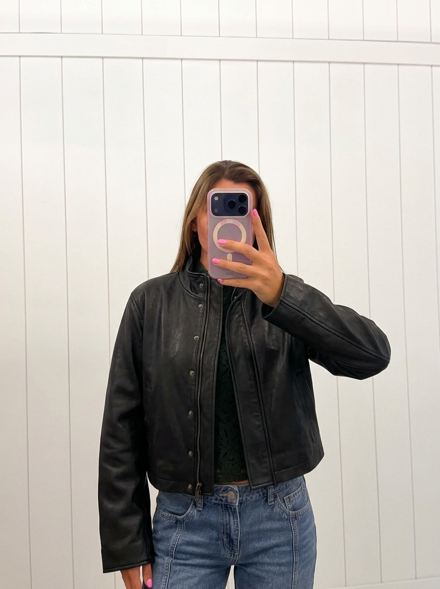 AI-assisted FASHN try-on of Black Collar Snap Button Leather Jacket on boutique owner.