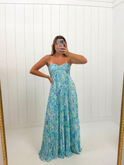 AI-assisted FASHN try-on of Blue Waive Accordion Maxi Dress on boutique owner.
