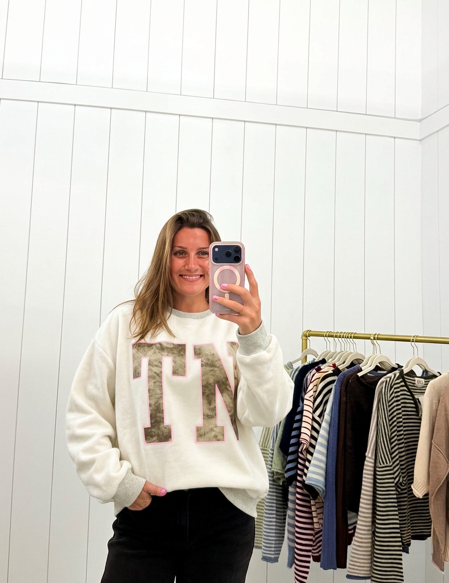 AI-assisted FASHN try-on of Grey & Camo Tennessee Crewneck TN Side on boutique owner.