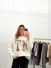 AI-assisted FASHN try-on of Grey & Camo Tennessee Crewneck TN Side on boutique owner.