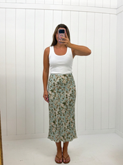 AI-assisted FASHN try-on of Green Floral Print Midi Skirt on boutique owner.