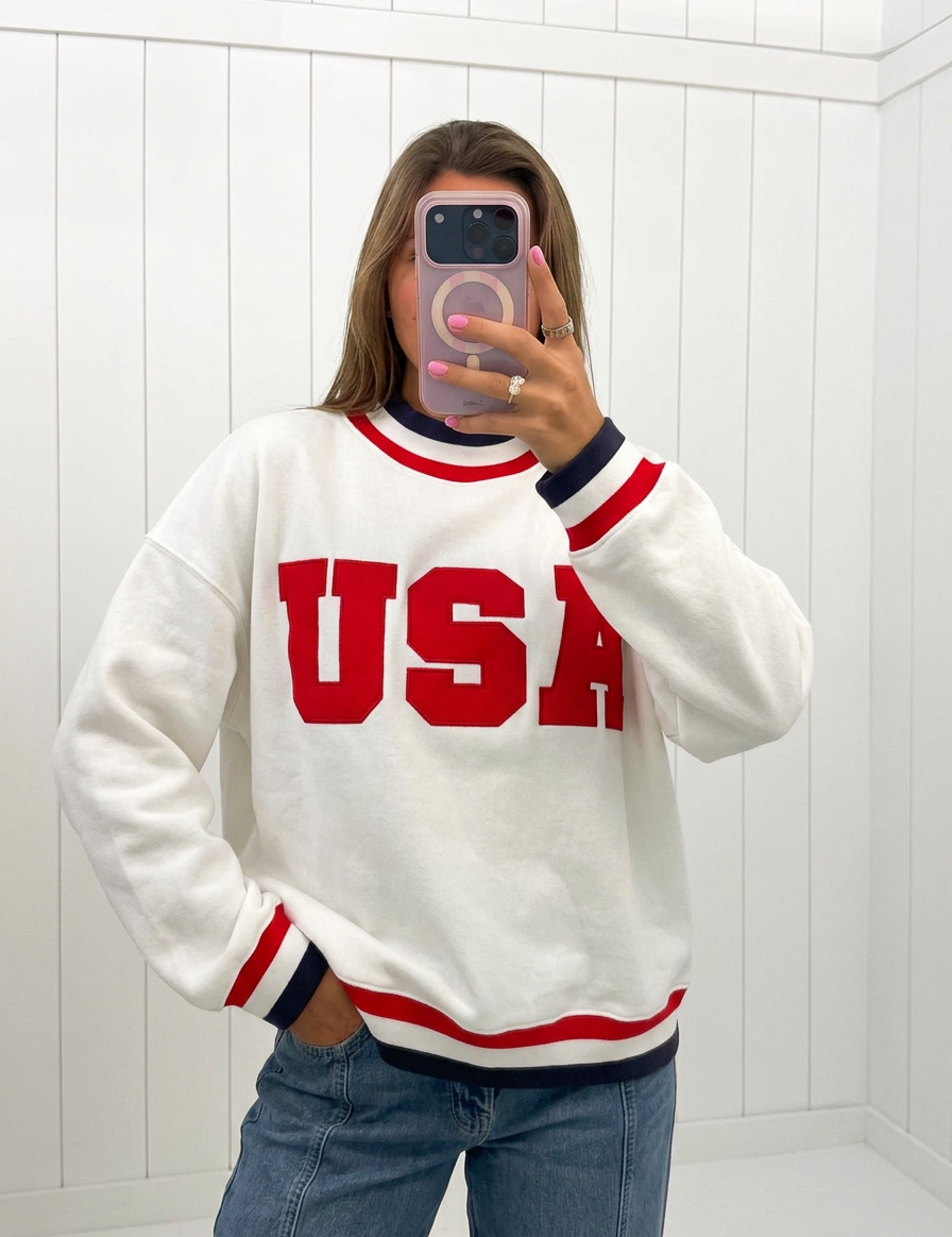 AI-assisted FASHN try-on of White USA Letter Trim Sweatshirt on boutique owner.