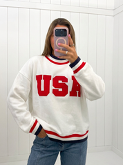AI-assisted FASHN try-on of White USA Letter Trim Sweatshirt on boutique owner.