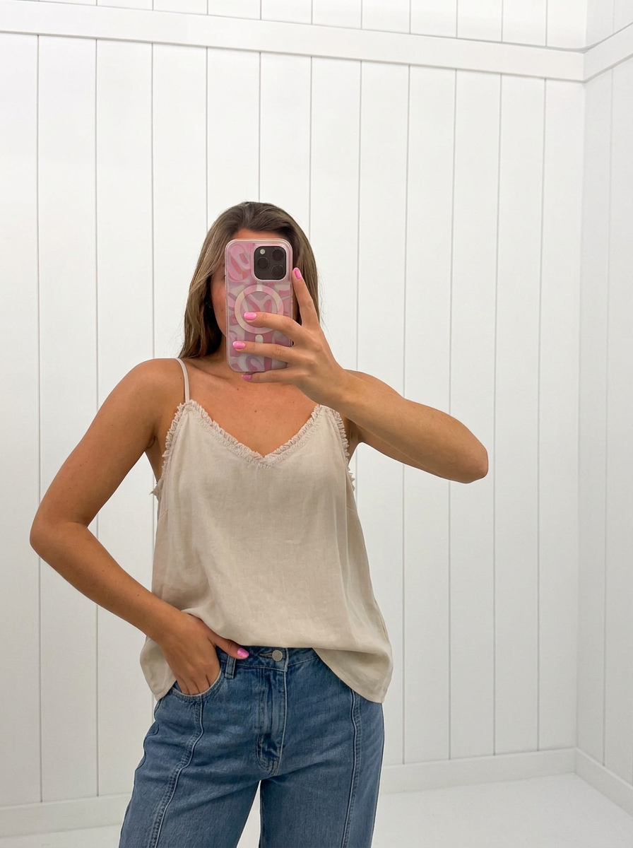 AI-assisted FASHN try-on of Beige V-Neck Spaghetti Strap Top on boutique owner.